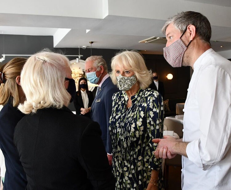 Britain’s Prince Charles and Camilla, the Duchess of Cornwall walk, during a visit to Clapham Old Town, to celebrate the high street and retail sector as non-essential shops re-open and coronavirus restrictions ease, in south London, Thursday May 27, 2021.