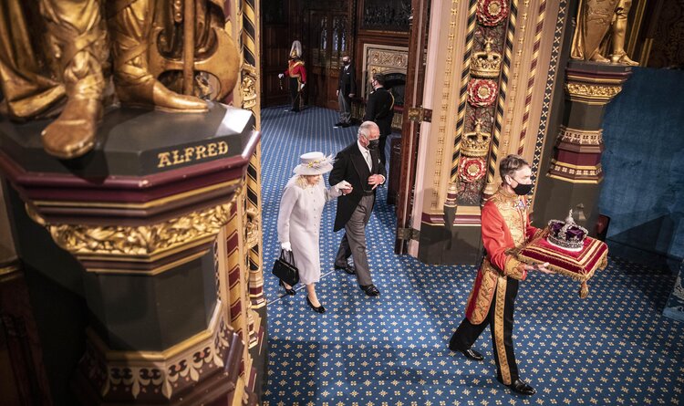 The Queen is escorted out of the House of Lords by Prince Charles and led by the imperial state crown following her speech during the state opening of Parliament. Due to the ongoing Corona pandemic guests in the royal gallery were limited and socially distanced.