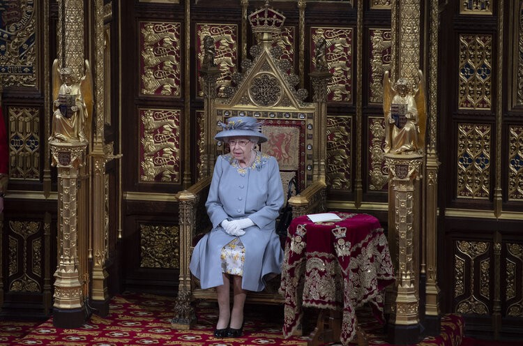 Britain’s Queen Elizabeth II and Britain’s Prince Charles, Prince of Wales walk behind the Imperial State Crown as they process through the Royal Gallery, before the Queen’s Speech, during the State Opening of Parliament at the Houses of Parliament in London on May 11, 2021, which is taking place with a reduced capacity due to Covid-19 restrictions. – The State Opening of Parliament is where Queen Elizabeth II performs her ceremonial duty of informing parliament about the government’s agenda for the coming year in a Queen’s Speech. The Queen is escorted out of the House of Lords by Prince Charles and led by the imperial state crown following her speech during the state opening of Parliament. Due to the ongoing Corona pandemic guests in the royal gallery were limited and socially distanced.